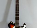 an electric guitar sitting on top of a table next to a white wall