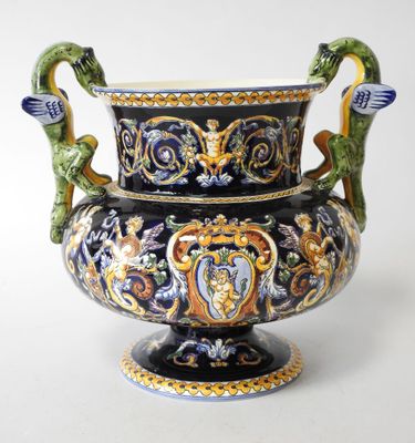 a large vase with a dragon handle on it