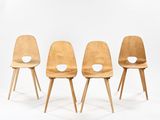 four wooden chairs with holes in the back of them on a white background
