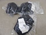 two pairs of gloves wrapped in plastic on the floor
