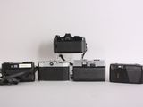 a lot of different types of cameras sitting on a table