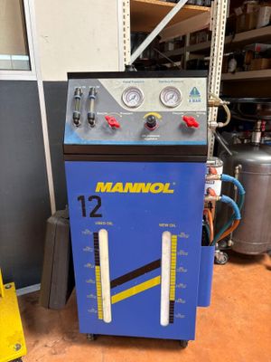 an image of a blue machine sitting on top of a wooden floor