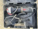a tool in a case that is sitting on the ground