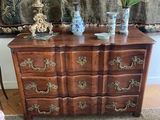 an image of a dresser and chair in a living room