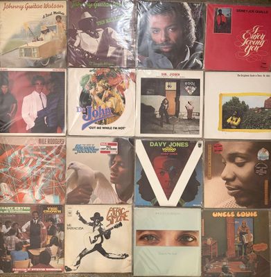 a lot of records on the wall of a room