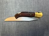 a close up of a knife with a wooden handle on a table