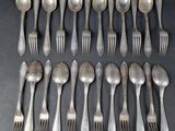 a lot of silver spoons and forks on the table