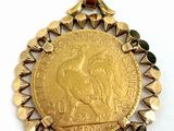 a close up of a gold coin on a white surface