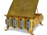 an image of a golden box with jewels on top of it