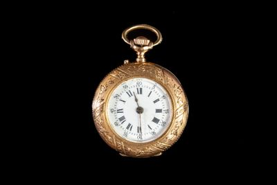 une montre de poche en or avec des chiffres romains