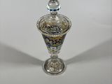 a silver and blue glass perfume bottle with a silver top