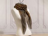 a mannequin with a leopard print scarf on it