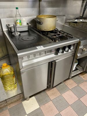 a kitchen with a stove, oven, sink, and dishwasher