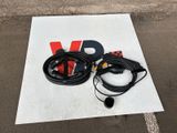 an image of a car charger and a cable on a parking lot