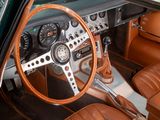 a steering wheel and dashboard of a car with a brown leather seat