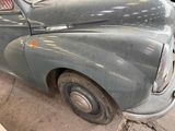 an old car that is sitting in a garage