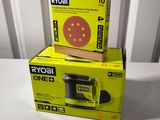 two boxes of ryobi sanders sitting on top of a white table