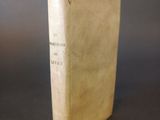 an old book sitting on top of a table with a black background