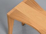 a wooden bench that has a curved design on it