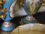 two vases and a bowl sitting on a table