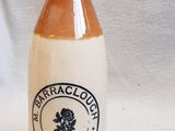 a brown and white bottle sitting on a table