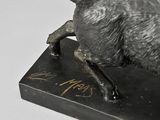 a statue of a bull that is standing on a box