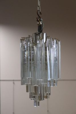 a glass chandelier hanging from a ceiling in a room