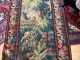 two rugs on the floor in a room with a table and chairs