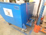 a blue dumpster sitting in the middle of a warehouse