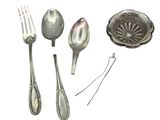 silver spoons, forks, and spoon rest on a white surface