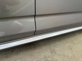 a close up of a car door handle and the door handle of the car