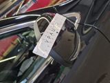 a parking meter attached to the side of a car