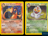 two pokemon cards with different designs on them on a black background