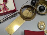 a table with various items that include scissors, a ring, a book, and a pair of scissors