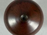 a wooden object that is on a white surface