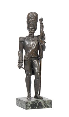 bronze statue of a man holding a staff and a sword