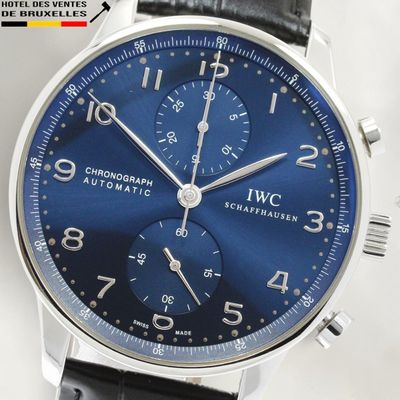 a close up of a wrist watch with a blue dial