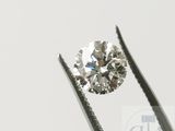 un gros plan d'un diamant tenu par une pince