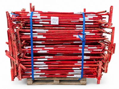 a stack of red scaffoldings on a wooden pallet