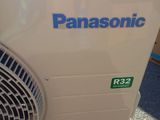 an air conditioner sitting on the ground next to a pile of boxes