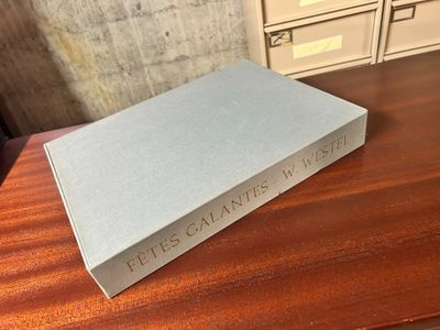 an open book sitting on top of a wooden table next to a file cabinet
