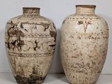 two vases sitting next to each other on a table