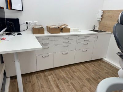 a desk with a computer and a chair in a room