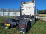 a semi truck that is parked in the grass