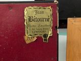 a red book sitting on top of a table next to a wooden box