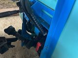 a blue machine that is sitting in the dirt