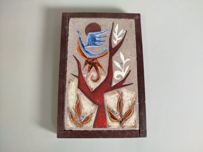 a picture of a bird on a tree on a wall