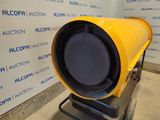 a yellow light that is on a stand in front of a wall