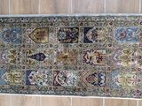 an image of a rug with fringes on a wooden floor