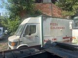 two trucks parked next to each other in a yard